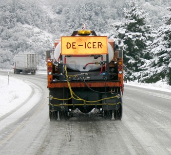 Road deicer spreading truck in winter