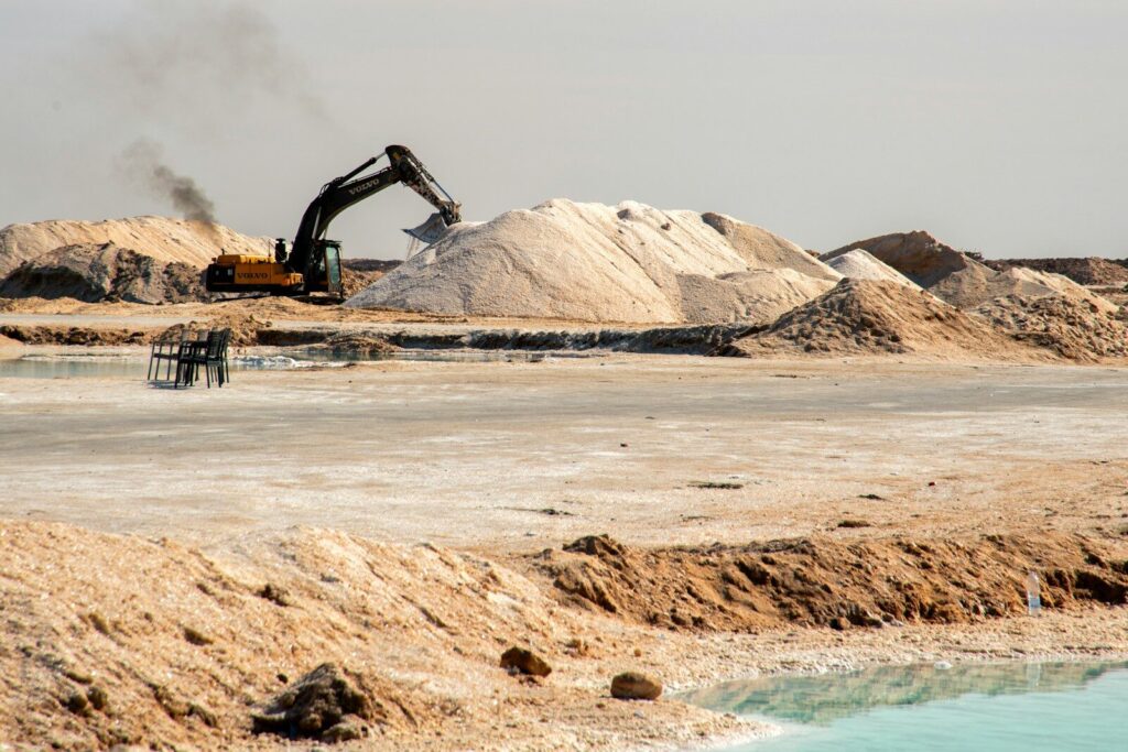 Excavator loading salt piles at a salt mine.